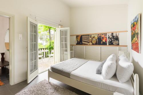 a bedroom with a bed with white pillows at Rose Willow, Vourvourou #FeelsLikeHome in Vourvourou