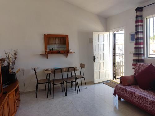 a living room with a table and chairs and a couch at Casa Joleen 1 in Villamartin