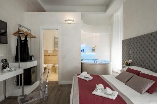 a bedroom with a bed and a bathroom with a tub at Hotel Navona in Rome