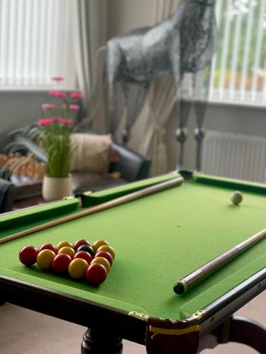 a pool table with balls on top of it at The Southbourne Villa in Torquay