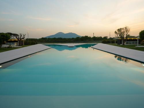 a swimming pool with a mountain in the background at Secret Garden Resort & Spa in Palma Campania