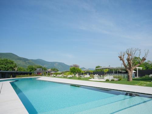 a swimming pool with blue water in front of a house at Secret Garden Resort & Spa in Palma Campania