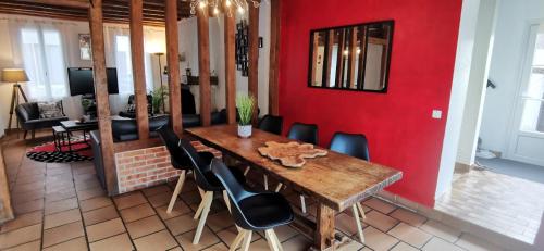 une salle à manger avec une table en bois et des chaises noires dans l'établissement Séjour cosy entre Beauval et Center Parc, à Selles-sur-Cher