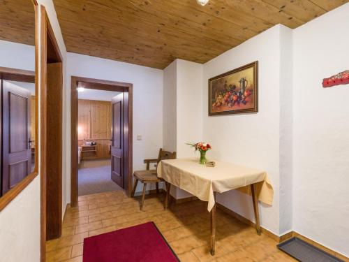a room with a table with a vase of flowers on it at Appartment Thumerhof Wildschönau in Niederau