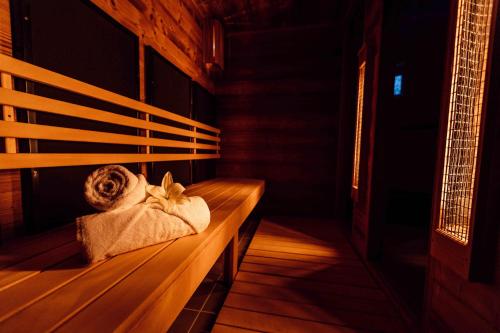 un banco de madera en una habitación con una toalla en Kistücsök Food & Room, en Balatonszemes