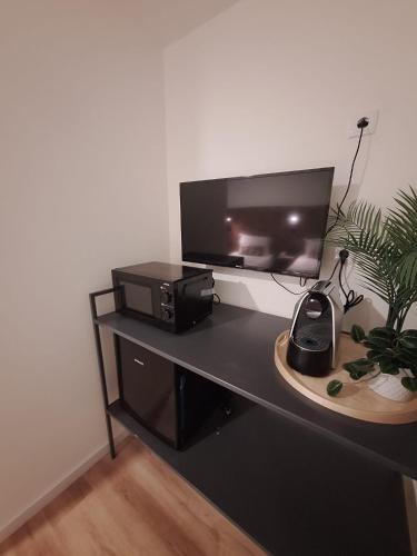 a desk with a computer monitor and a printer on it at Hotel Portucalense in Porto