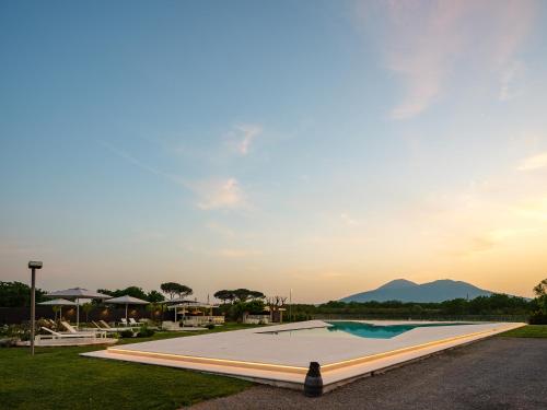 a pool at a resort with mountains in the background at Secret Garden Resort & Spa in Palma Campania