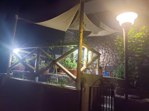 a table with a white umbrella and a street light at Turchese in Amalfi