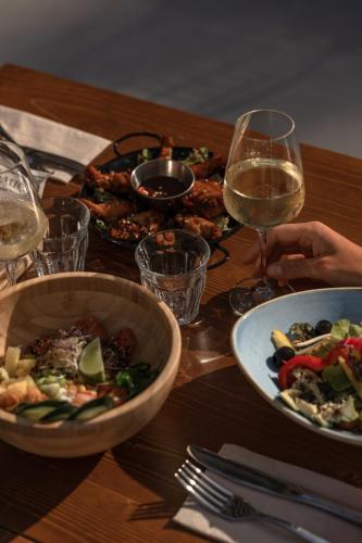 a table with plates of food and a glass of wine at Cooks Club Calvia Beach - Adults Only in Magaluf