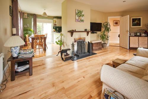 a living room with a wooden floor and a fireplace at Killaloe/Ballina in Ballina