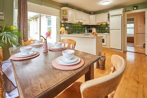 a kitchen and dining room with a wooden table and chairs at Killaloe/Ballina in Ballina