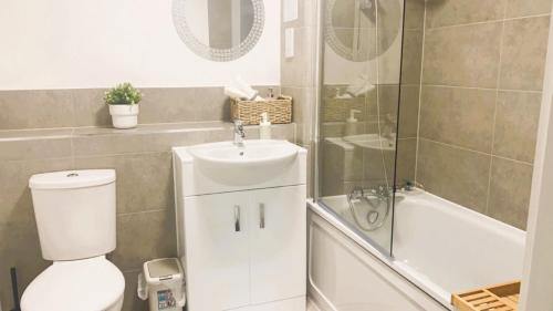 a bathroom with a toilet and a sink and a shower at Bridgefield Apartment in Ashford