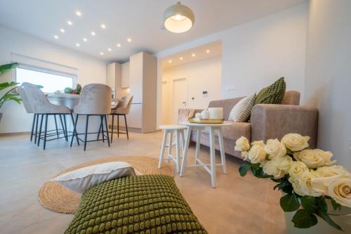 a living room with a couch and a table at Luxury Villa Del Sogno with pool, jacuzzi, parking in Trogir