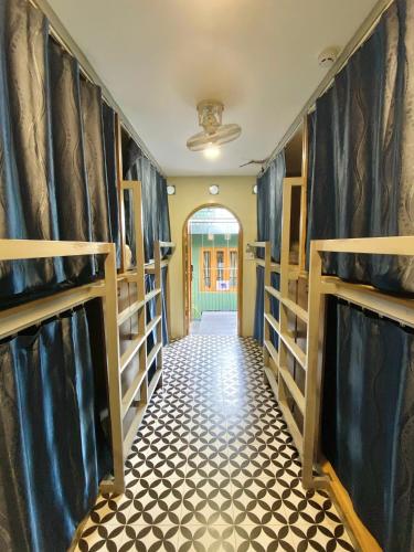 a hallway of a room with shelves and a floor at VY DA CENTRAL MARKET HOSTEL in Ho Chi Minh City