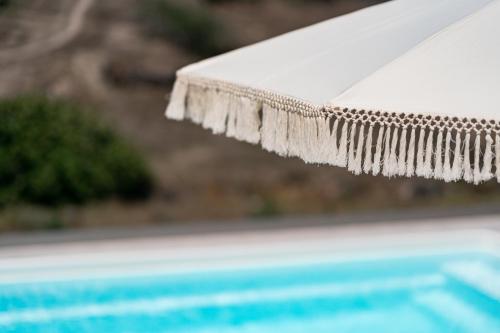 a close up of a swimming pool with water dripping from a hose at Alegria by Casa Sigalas in Oia
