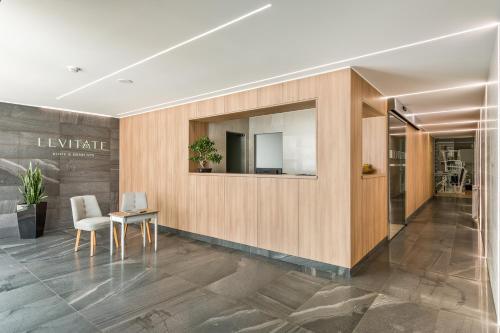 an office lobby with a table and a mirror at Hotel Do Parque - Congress & SPA in Termas de Sao Pedro do Sul