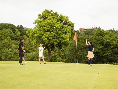 a group of people playing golf on a putting green at Hole 37 in Tsukuba
