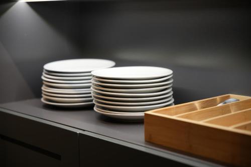 a stack of plates sitting on top of a counter at Hotel Urbani in Turin