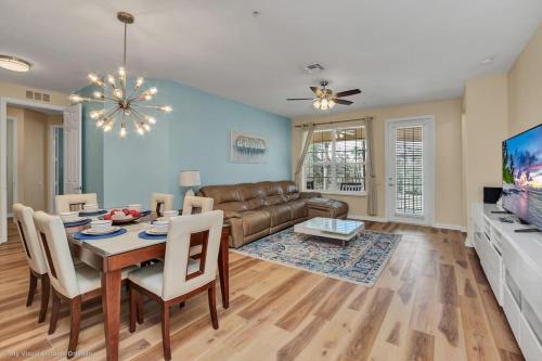 a living room with a table and a couch at The Epic Lisbon Vista Cay Orlando in Orlando