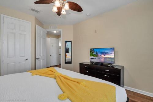 a bedroom with a bed and a flat screen tv at The Epic Lisbon Vista Cay Orlando in Orlando