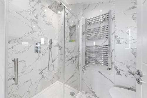 a bathroom with a shower with a glass door at SERCASA - The Hyde - Hendon Station in The Hyde