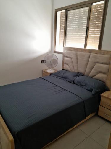 a bedroom with a large bed and a window at المغرب القنيطره in Kenitra