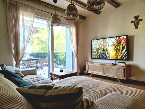 a living room with a bed and a tv at Apartment Mia La Verna in Orebić