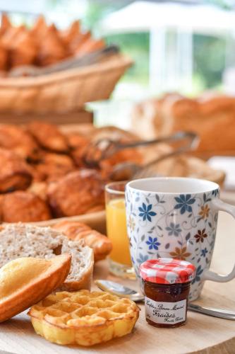 a table topped with a cup of coffee and bread at Novotel Paris Créteil Le Lac in Créteil