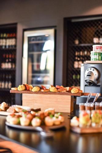 a counter with several levels of bread and pastries at Novotel Paris Créteil Le Lac in Créteil
