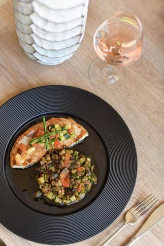 a plate of food with a slice of pizza on a table at Novotel Paris Créteil Le Lac in Créteil