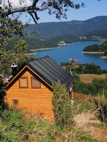 a wooden cabin with a view of a lake at Vila Bella, Tara, Zaovinsko jezero in Zaovine