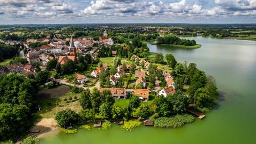 an aerial view of a small town on a lake at Domy nad Jeziorem Sun & Snow Osada Zamkowa in Pasym