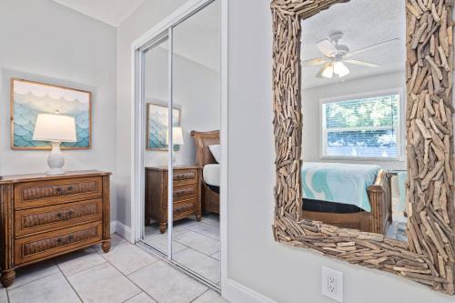 a mirror in a room with a bedroom at Beachy 2-1 Condo in Palm Harbor