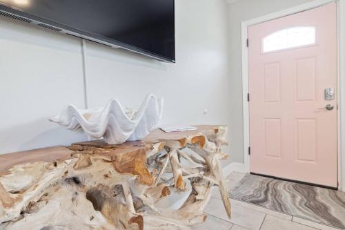 a room with a wooden table next to a door at Beachy 2-1 Condo in Palm Harbor