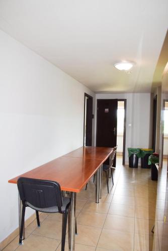 a large wooden table in a room with chairs at Noclegi Rzeszów in Rzeszów