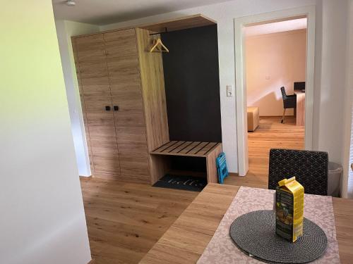 a dining room with a table and a room with a closet at Ferienwohnungen Fellhornblick in Riezlern