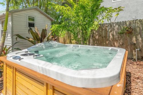 a hot tub in a backyard with a fence at Catch the Breeze on Crystal Beach in Palm Harbor