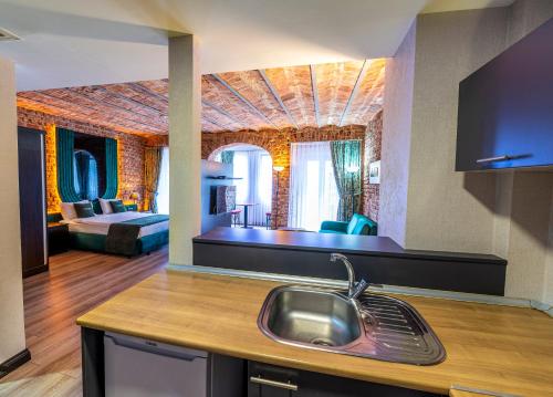 a kitchen with a sink and a living room at Karakoy Aparts Hotel - Special Category in Istanbul