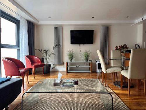 a living room with a couch and a table at Canary Wharf - Luxury Apartments in London