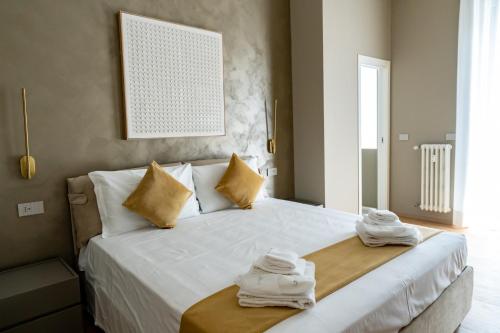 a bedroom with a bed with towels on it at Heart Milan Apartments San Sepolcro Duomo in Milan