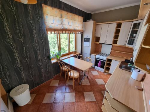 a small kitchen with a table and chairs in it at Great View Meridianas Apartment in Klaipėda