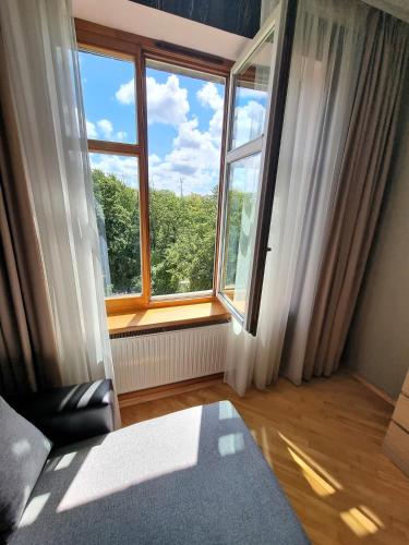 an empty room with a large window with a view at JS apartamentai su savarankišku įsiregistravimu in Klaipėda