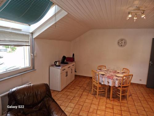a kitchen with a table and chairs in a room at HAUT-DOUBS Logis in Morteau