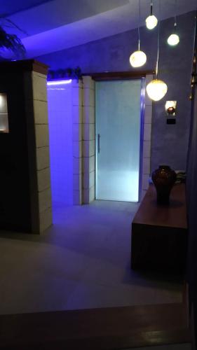 a door in a room with a blue light at Private Romantic Wellness Lake View Retreat- Whirlpool Hammam Spa e Piscina panoramica in Maccagno con Pino e Veddasca