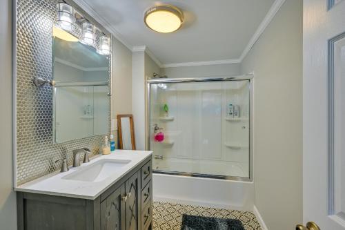 a white bathroom with a shower and a sink at Weymouth Waterfront Getaway with Swim Spa and Hot Tub in Weymouth