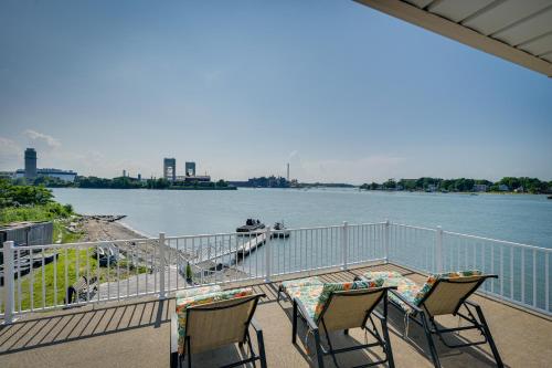 a balcony with chairs and a view of a river at Weymouth Waterfront Getaway with Swim Spa and Hot Tub in Weymouth