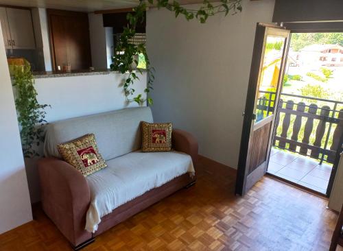 a couch with two pillows on it in a room at Homestay Zajec in Grosuplje