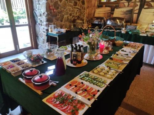 a long table with many different types of food at Hotel Spichrz in Borcz