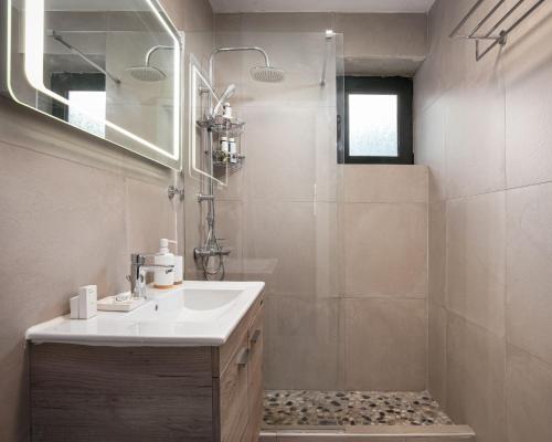 a bathroom with a sink and a shower at K Waterfront Residence In Mani in Áyios Kiprianós
