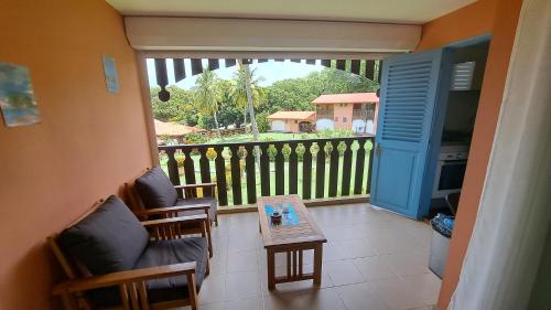 a view of a balcony with a table and chairs at studio plage de l'anse caritan in Sainte-Anne